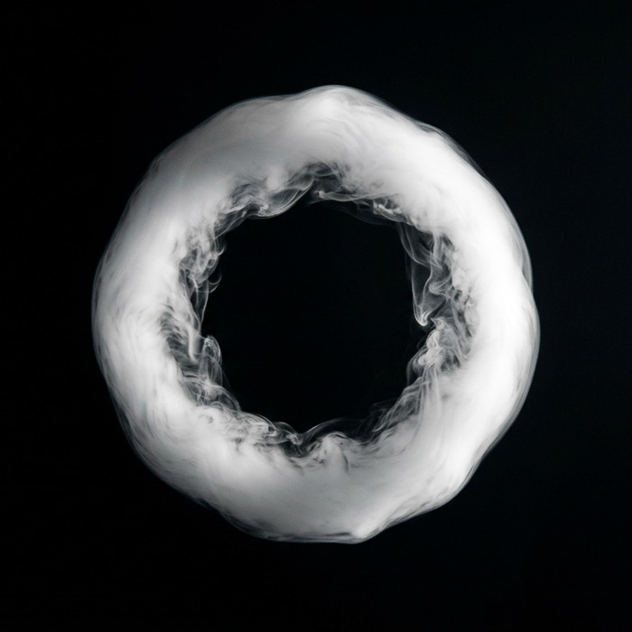 Perfect thick vape smoke ring (O-ring) trick on black background